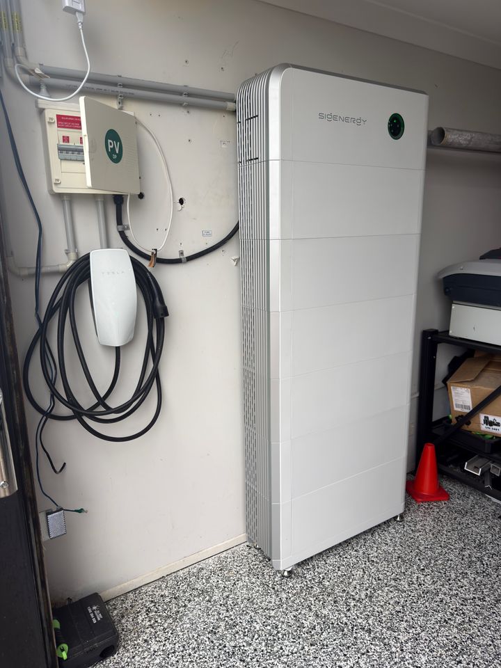 Sigenergy commercial battery stack installed at a Northern Rivers factory, beside an EV charger