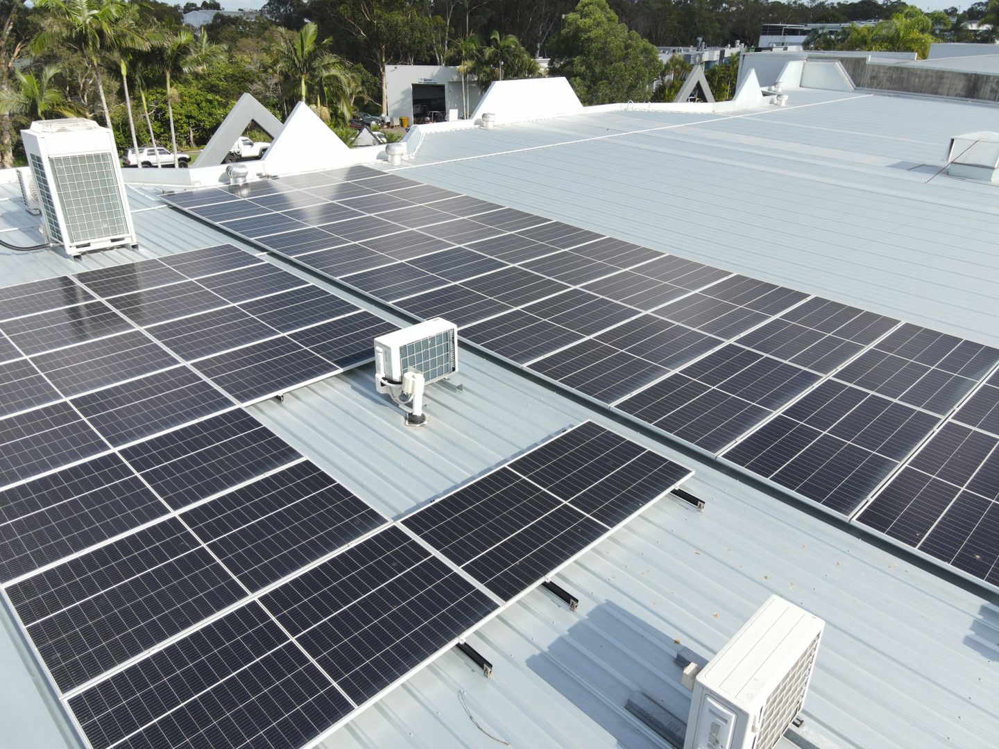Drone photo of a large commercial solar array installed across the Media Booth building roof