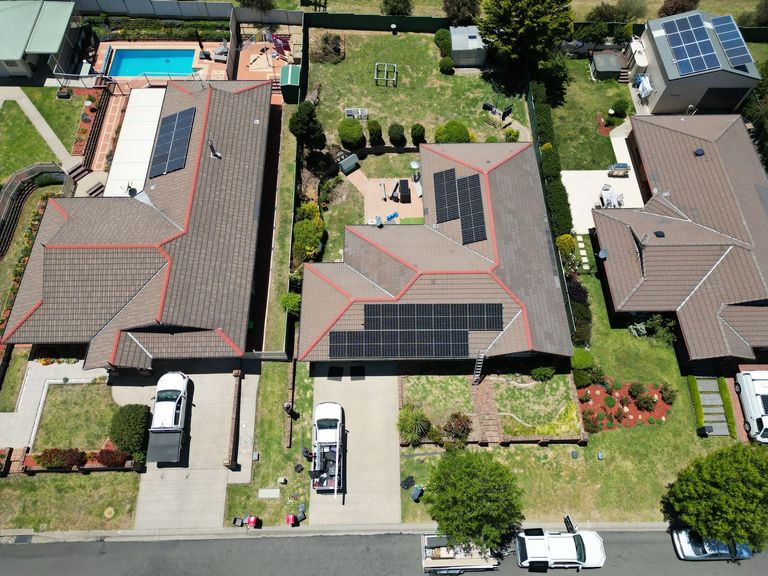 Drone photo of an Armidale rooftop solar installation with the work ute below
