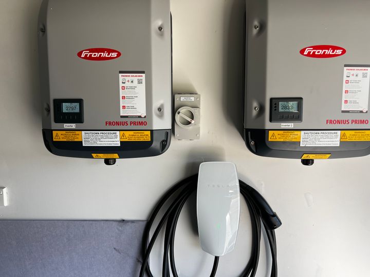 Fronius inverter with EV charger on a residential wall